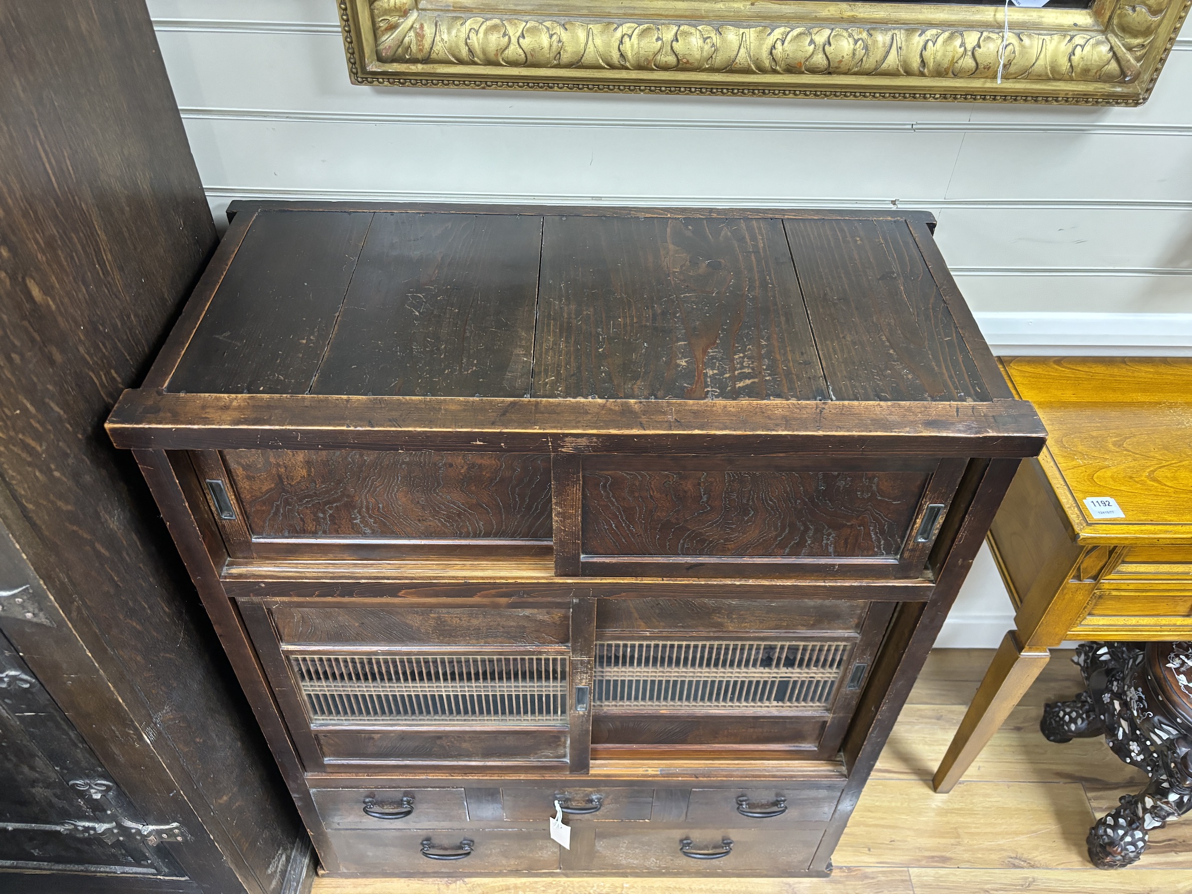 A Japanese hardwood cabinet, fitted with drawers and sliding panels, width 88cm, depth 42cm, height 104cm